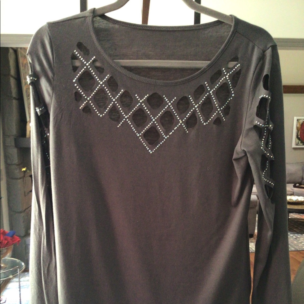 Grey long sleeve top, trimmed cutouts below neck and down both arms.